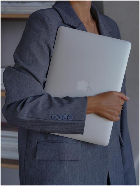 Professional woman holding a laptop in an office s