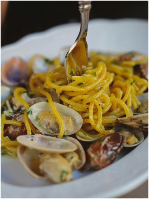 A close-up shot of delicious seafood pasta with cl