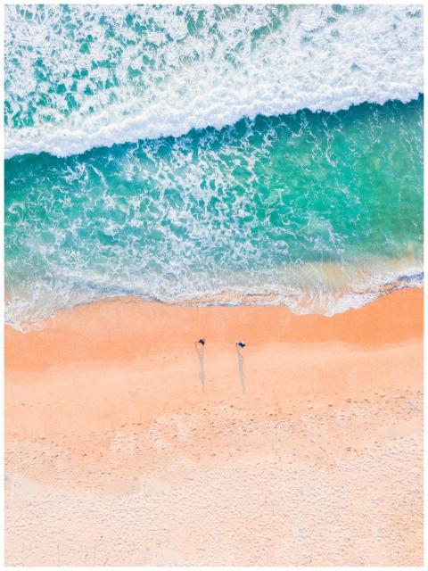 Stunning aerial shot of a sandy beach with turquoi