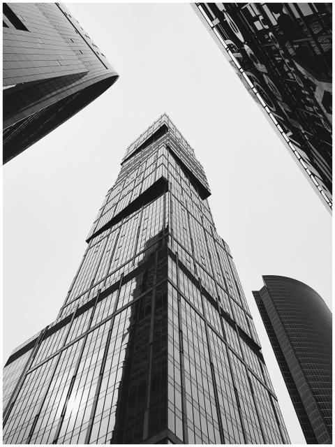 A dramatic black and white view of skyscrapers in
