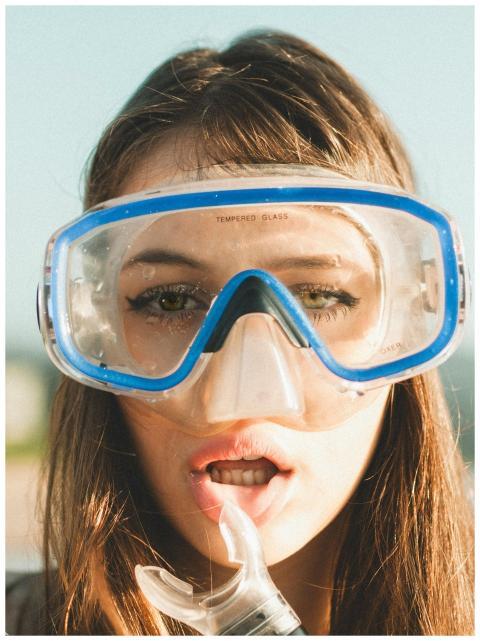 Close-up of a young woman wearing snorkeling goggl