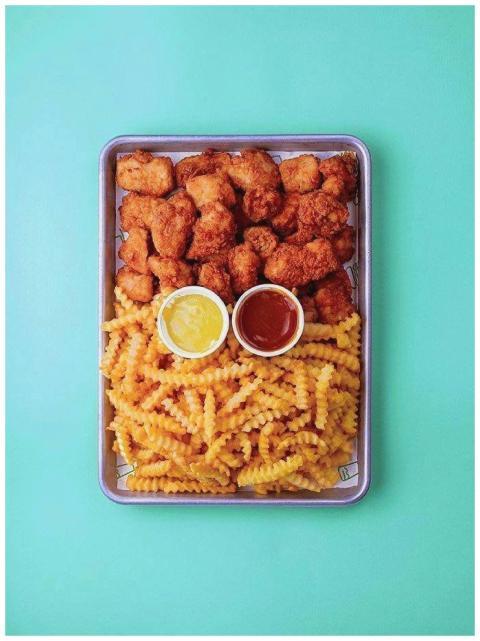 Tray of crispy chicken bites and crinkle-cut fries