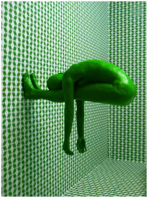 Artistic green human figure against a patterned an