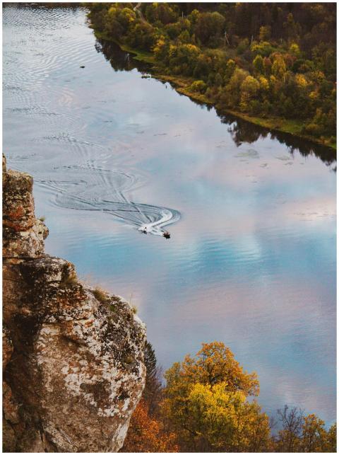 Breathtaking aerial view of a tranquil river surro