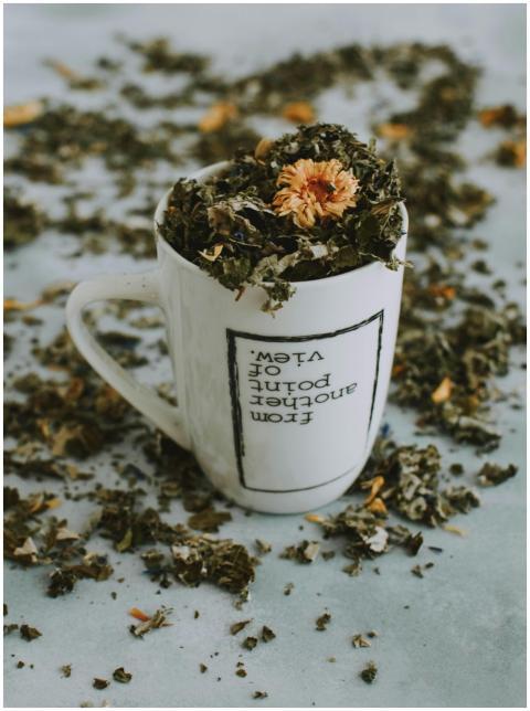A close-up of an herbal tea mug filled with dried