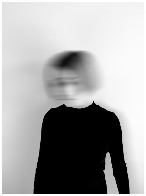 Black and white silhouette of a woman with a blurr