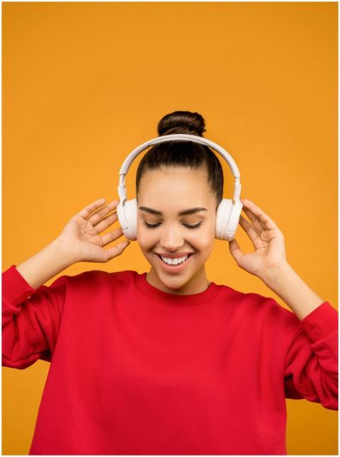 Young woman smiling and listening to music with he