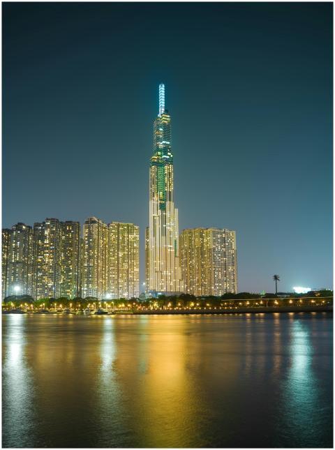 Illuminated skyscraper Landmark 81 reflecting on w