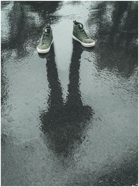 Creative photo of sneakers with a human reflection