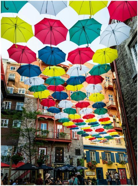 A vibrant street in Quebec City decorated with col