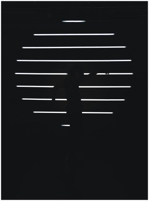 Dark silhouette moving against illuminated horizon