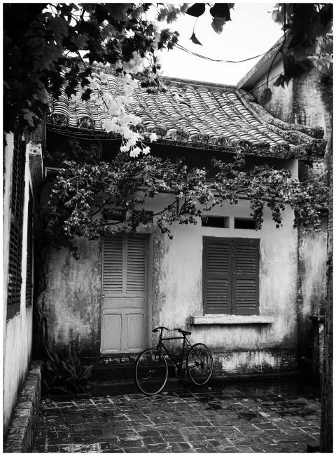 Black and white photo of a vintage home exterior w
