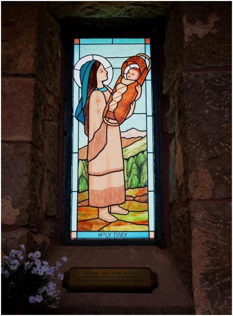 Stained glass window of Holy Mary holding a child