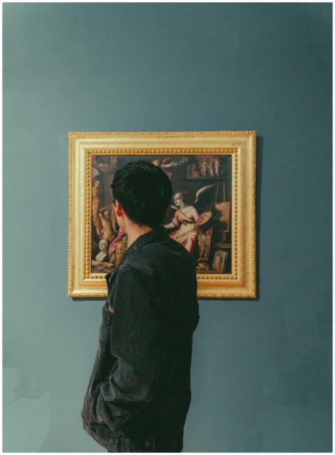 A man stands thoughtfully observing a classic fram