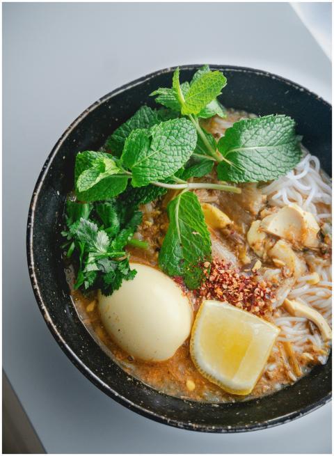 Close-up of a flavorful Asian noodle soup with egg