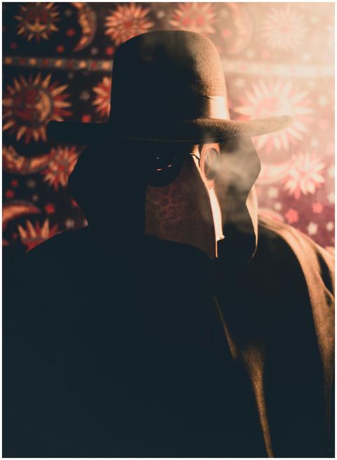 A mysterious figure in a plague doctor costume env