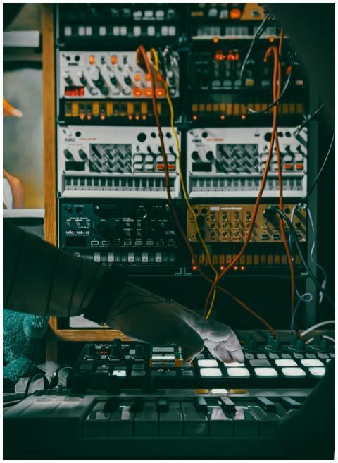 Musician using a synthesizer and controllers in a