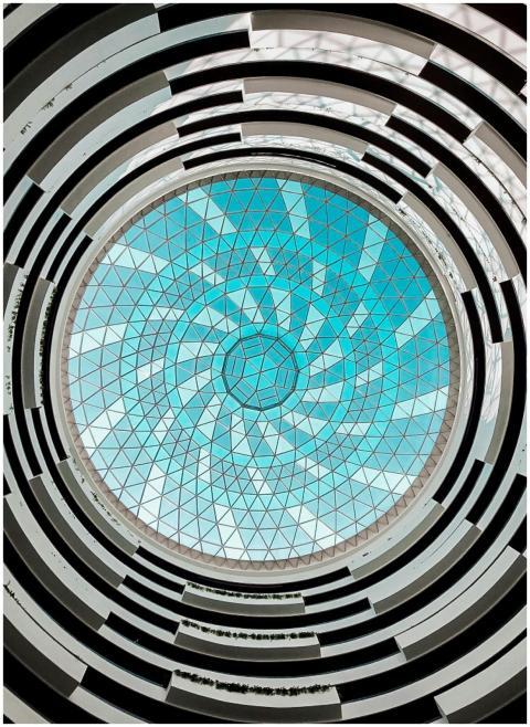 Low angle view of a circular glass dome ceiling fe