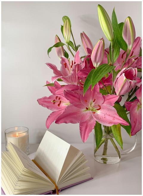 A beautiful arrangement of pink lilies in a glass