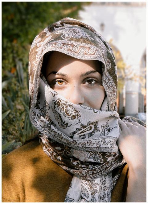 Close-up portrait of a woman wearing an ornate hea