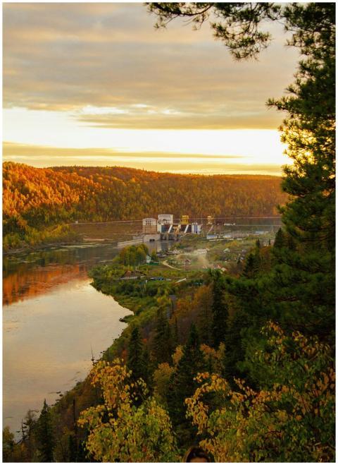 Scenic autumn landscape with a river and dam at go