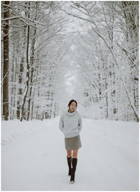 Woman strolling through a tranquil snow-covered fo