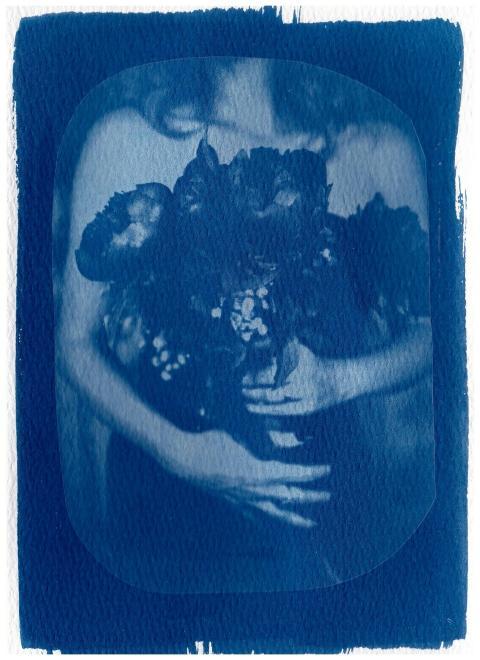Elegant cyanotype print shows a woman embracing fl