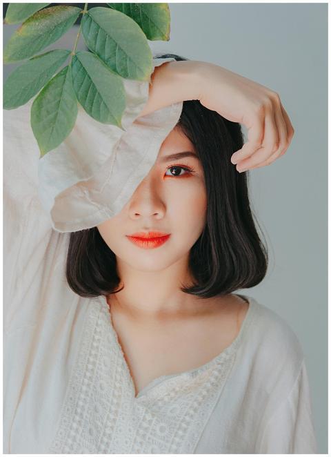 Serene portrait of a woman with leaves, perfect fo