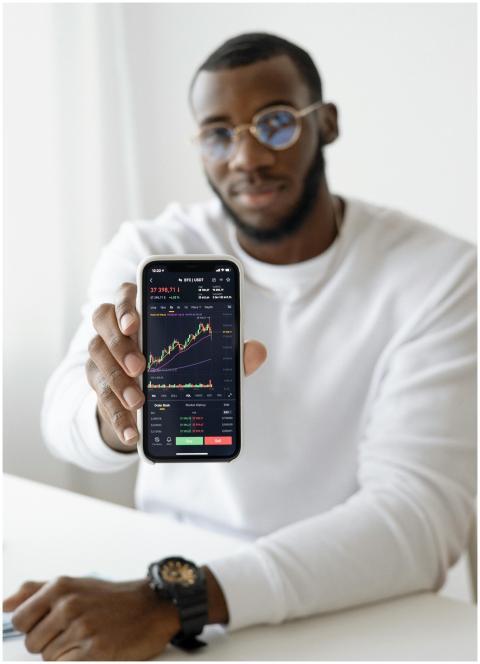 Businessman showing stock graph on smartphone, sym