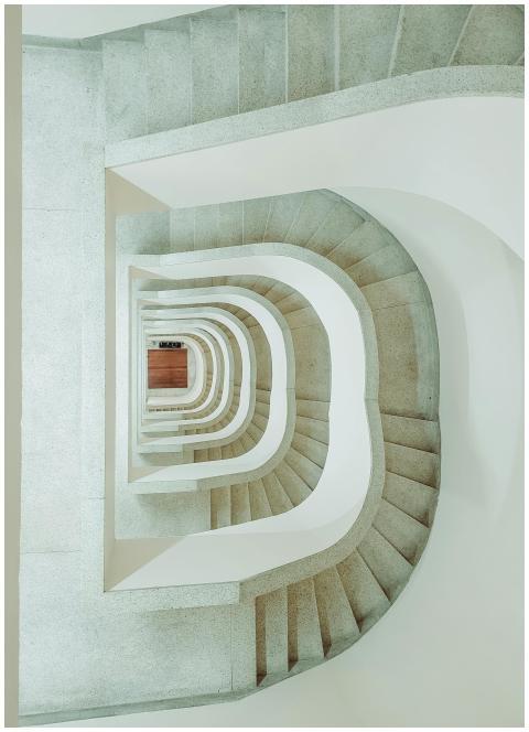 Minimalist vertical view of a spiral staircase in