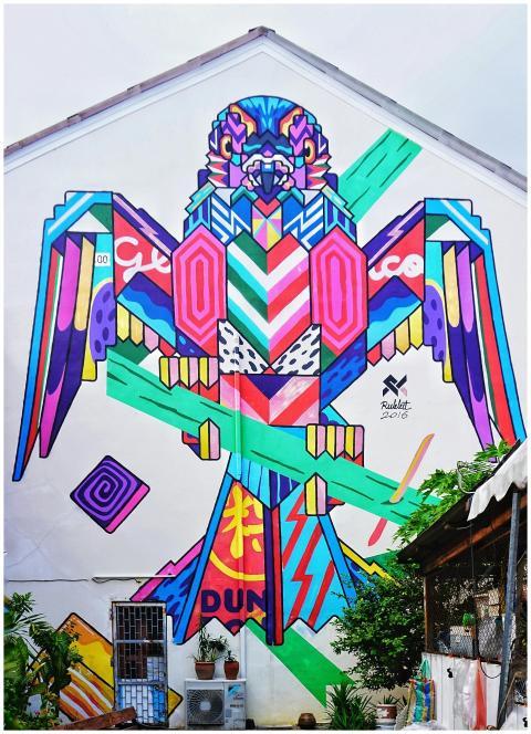 Colorful geometric street art mural on a building