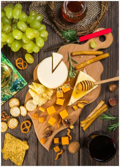 A delicious assortment of cheeses, crackers, and g