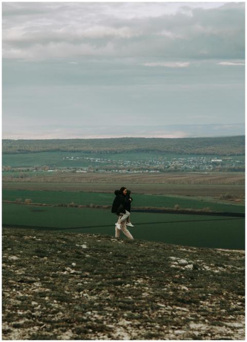 A couple enjoying a scenic walk on a hillside over