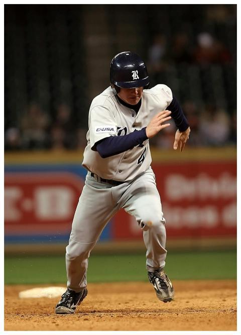 A baseball player in motion on the field, showcasi