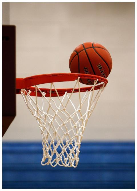 A basketball moment captured as the ball rests on