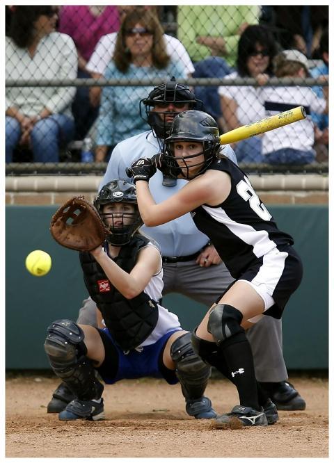Exciting softball game with catcher and batter in