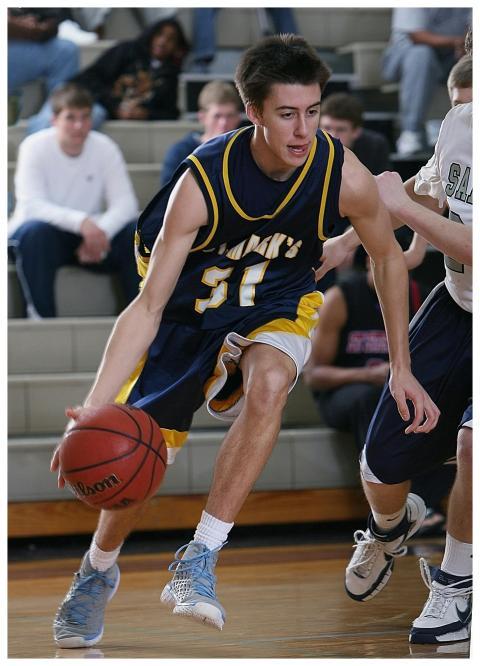 Teen basketball player dribbling during an intense