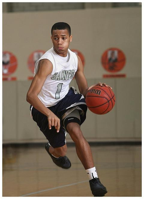 Energetic basketball player in mid-dribble on an i
