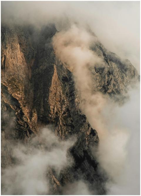 A serene view of mist-covered rocky mountains in K