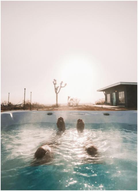 Person enjoying a steamy hot tub with desert lands