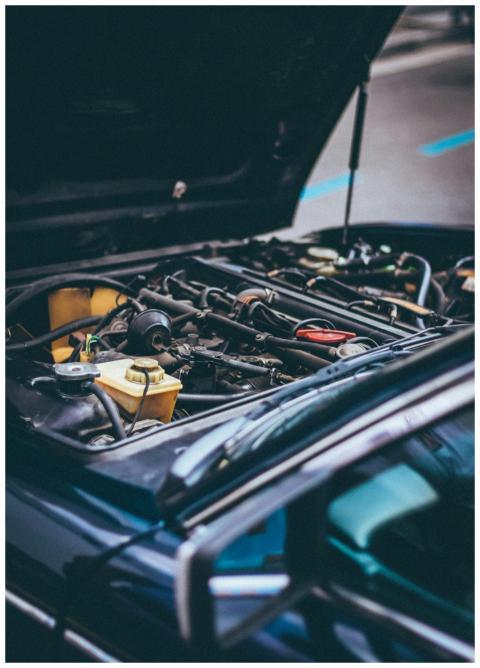 Detailed view of an exposed car engine under maint