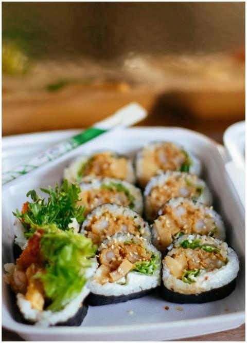Appetizing sushi rolls in a takeaway box, perfect