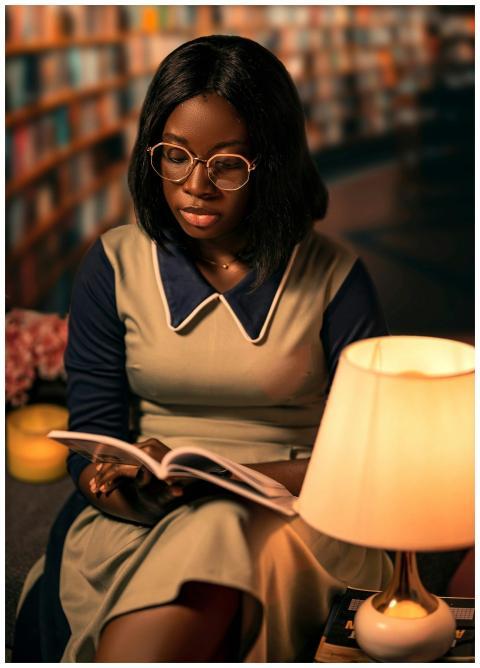 Woman reading a book in a cozy library setting wit