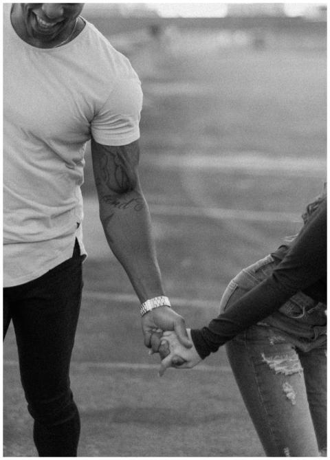 A stylish black and white photo of a couple holdin