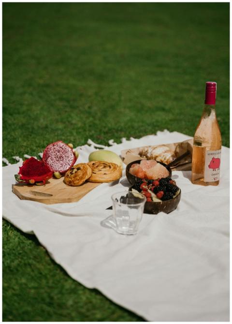 A delightful outdoor picnic setup featuring wine,