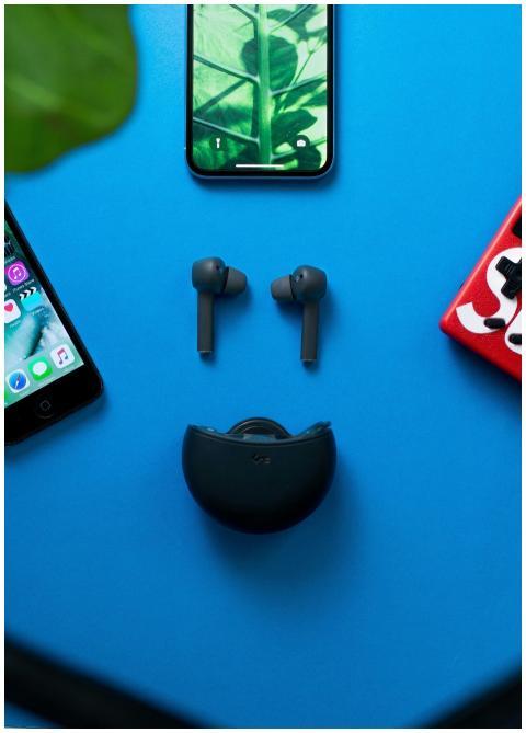 Flat lay of wireless headphones and smartphones on