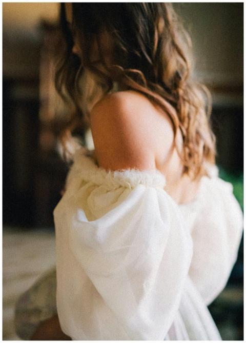 Close-up of a brunette woman in an off-shoulder wh