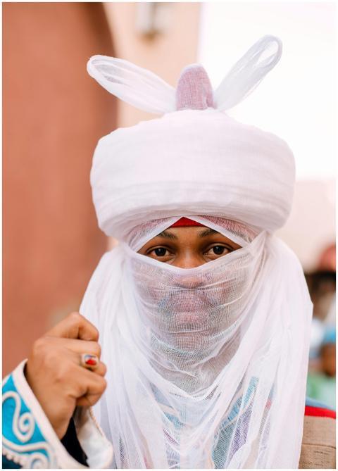 Man wearing traditional Hausa attire with intricat