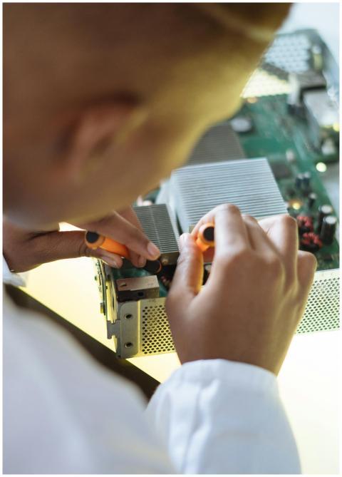 Crop of ethnic system administrator in uniform usi