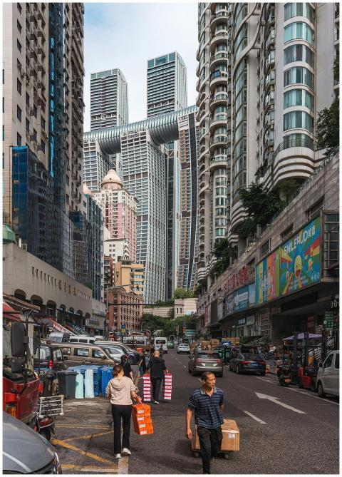 A vibrant city street scene featuring modern skysc